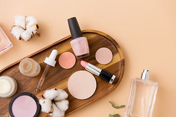 Image showing makeup, perfume and cosmetics on wooden tray