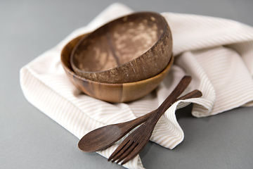 Image showing close up of coconut bowl, wooden spoon and fork