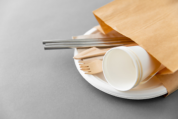 Image showing wooden forks, knives and paper cups on plate