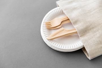 Image showing wooden forks and knives on paper plates and napkin