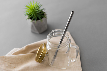 Image showing empty glass mug of with reusable metallic straw