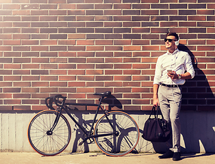 Image showing man with headphones, smartphone and bicycle