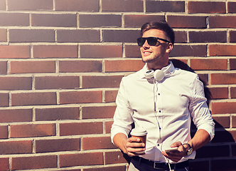 Image showing man with smartphone and coffee cup on city street