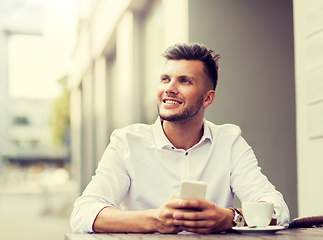 Image showing man with smartphone and coffee at city cafe