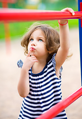 Image showing Cute little girl is playing in playground