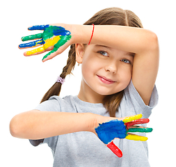 Image showing Portrait of a cute girl playing with paints