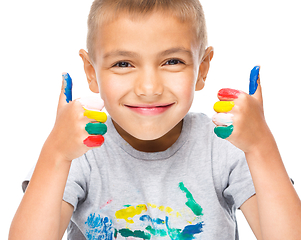 Image showing Portrait of a cute boy playing with paints