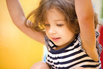 Image showing Cute little girl is playing in playground