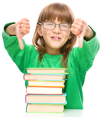 Image showing Little girl is reading a book