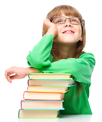 Image showing Little girl is reading a book