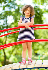 Image showing Cute little girl is playing in playground