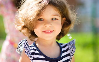 Image showing Cute little girl is playing in playground