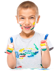 Image showing Portrait of a cute boy playing with paints