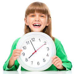 Image showing Little girl is holding big clock