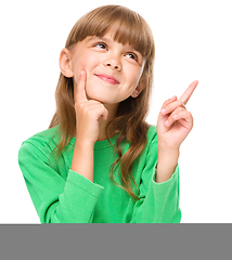Image showing Portrait of a young girl pointing up