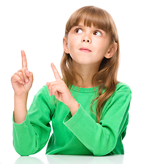 Image showing Portrait of a young girl pointing up