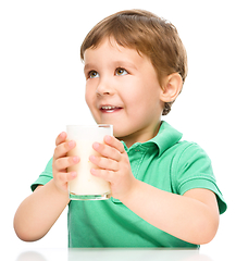 Image showing Cute little boy with a glass of milk