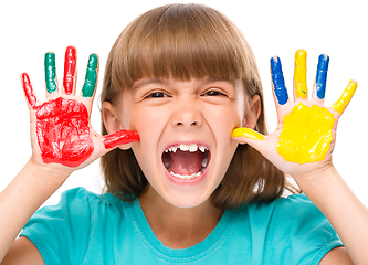 Image showing Portrait of a cute girl playing with paints