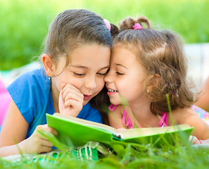 Image showing Two little girls are reading book