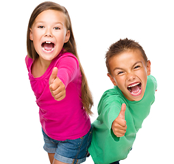 Image showing Little boy and girl are showing thumb up sign
