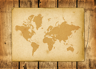 Image showing Vintage world map parchment on a wooden wall