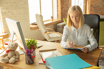 Image showing A young businesswoman moving in office, getting new work place