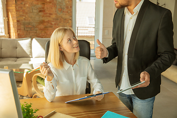 Image showing A young businesswoman moving in office, getting new work place