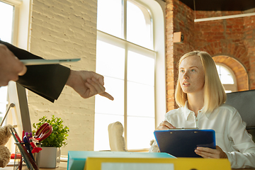 Image showing A young businesswoman moving in office, getting new work place