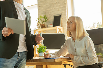 Image showing A young businesswoman moving in office, getting new work place