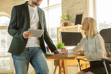 Image showing A young businesswoman moving in office, getting new work place