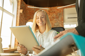 Image showing A young businesswoman moving in office, getting new work place