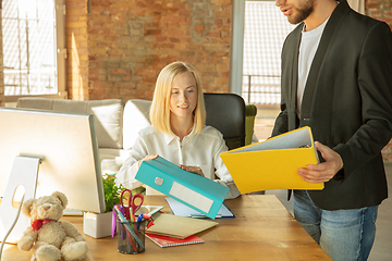 Image showing A young businesswoman moving in office, getting new work place