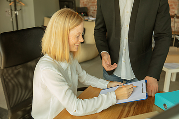 Image showing A young businesswoman moving in office, getting new work place