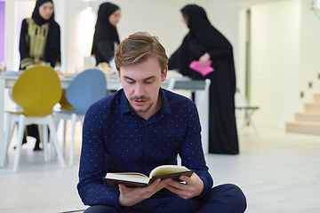 Image showing Young muslim man reading Quran during Ramadan