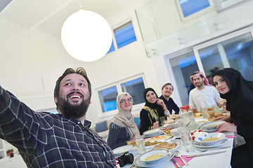 Image showing Muslim family taking selfie while having iftar together during Ramadan