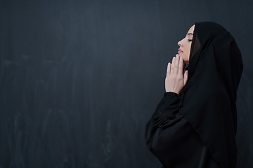 Image showing Portrait of young Muslim woman making dua