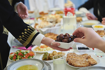 Image showing Muslim family starting iftar with dates during Ramadan