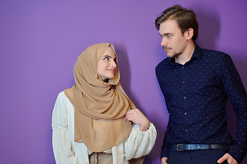 Image showing Portrait of happy young muslim couple standing isolated on colorful background