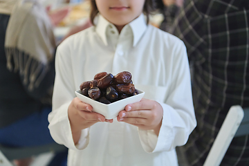 Image showing Arabian kid in the traditional clothes during iftar