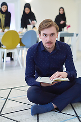 Image showing Young muslim man reading Quran during Ramadan