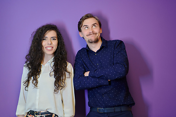 Image showing Happy young couple posing on purple background