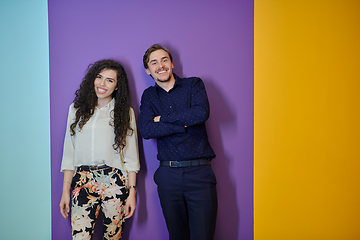 Image showing Happy young couple posing on purple background