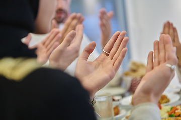 Image showing Muslim family making iftar dua to break fasting during Ramadan