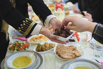 Image showing Muslim family starting iftar with dates during Ramadan