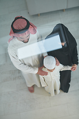 Image showing Top view of young arabian muslim family wearing traditional clothes