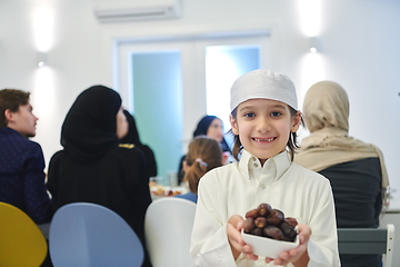 Image showing Arabian kid in the traditional clothes during iftar