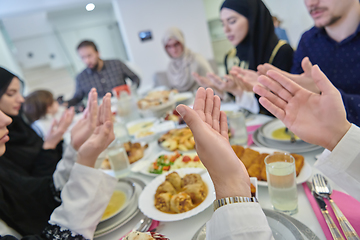 Image showing Muslim family making iftar dua to break fasting during Ramadan.