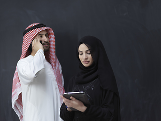 Image showing Young muslim business couple using technology devices