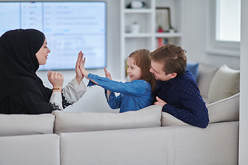 Image showing Happy Muslim family spending time together in modern home