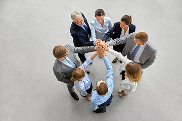 Image showing business people making high five in office